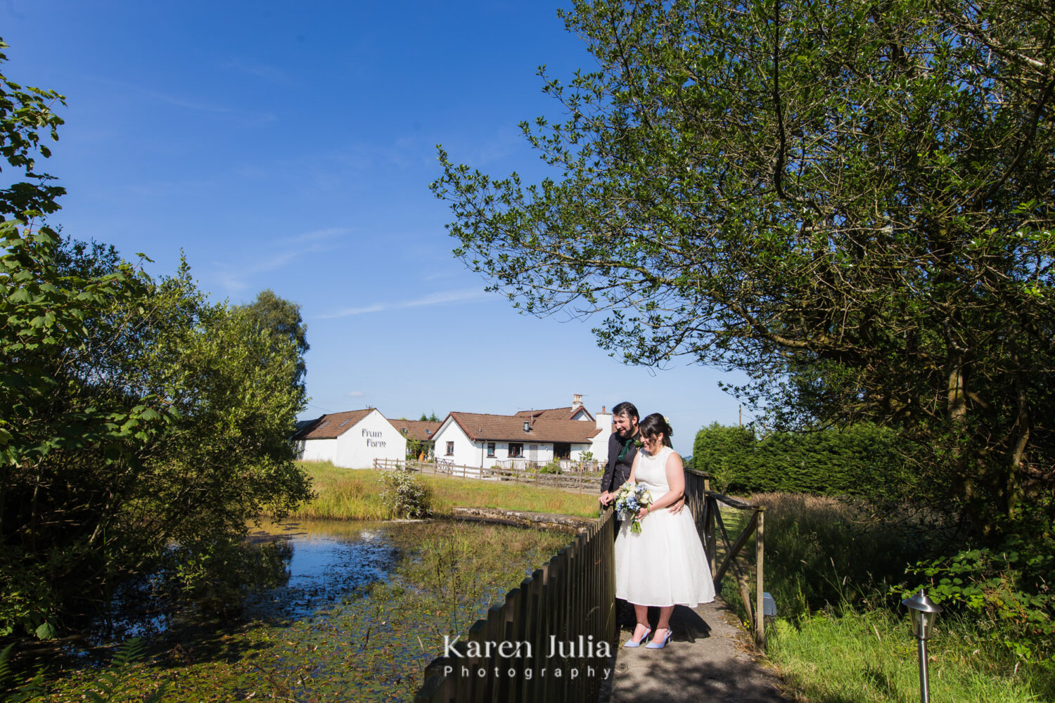 bride and groom wedding portrait next to the Fruin Farm pond.