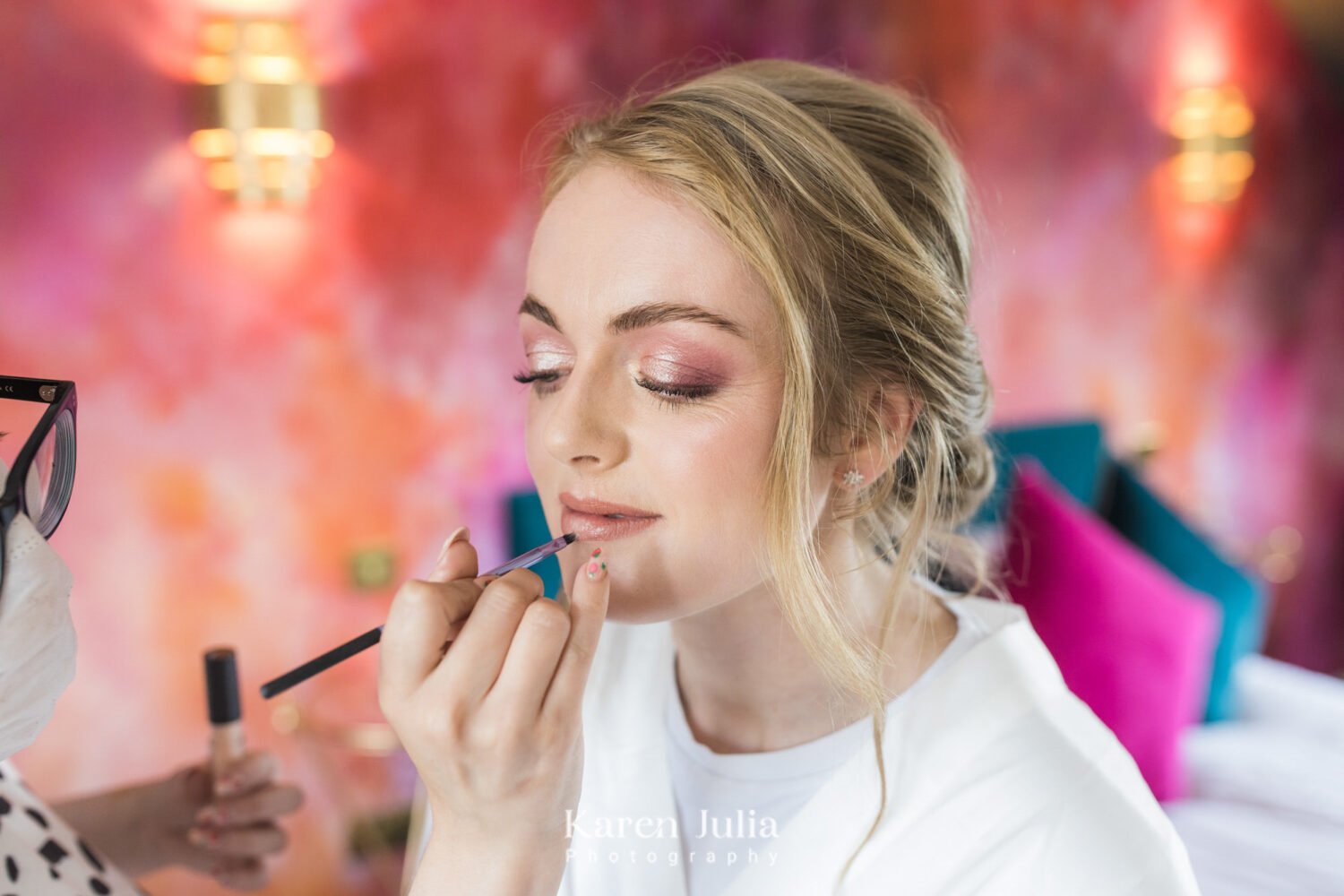 bride getting makeup applied in the bridal suit at Fruin Farm