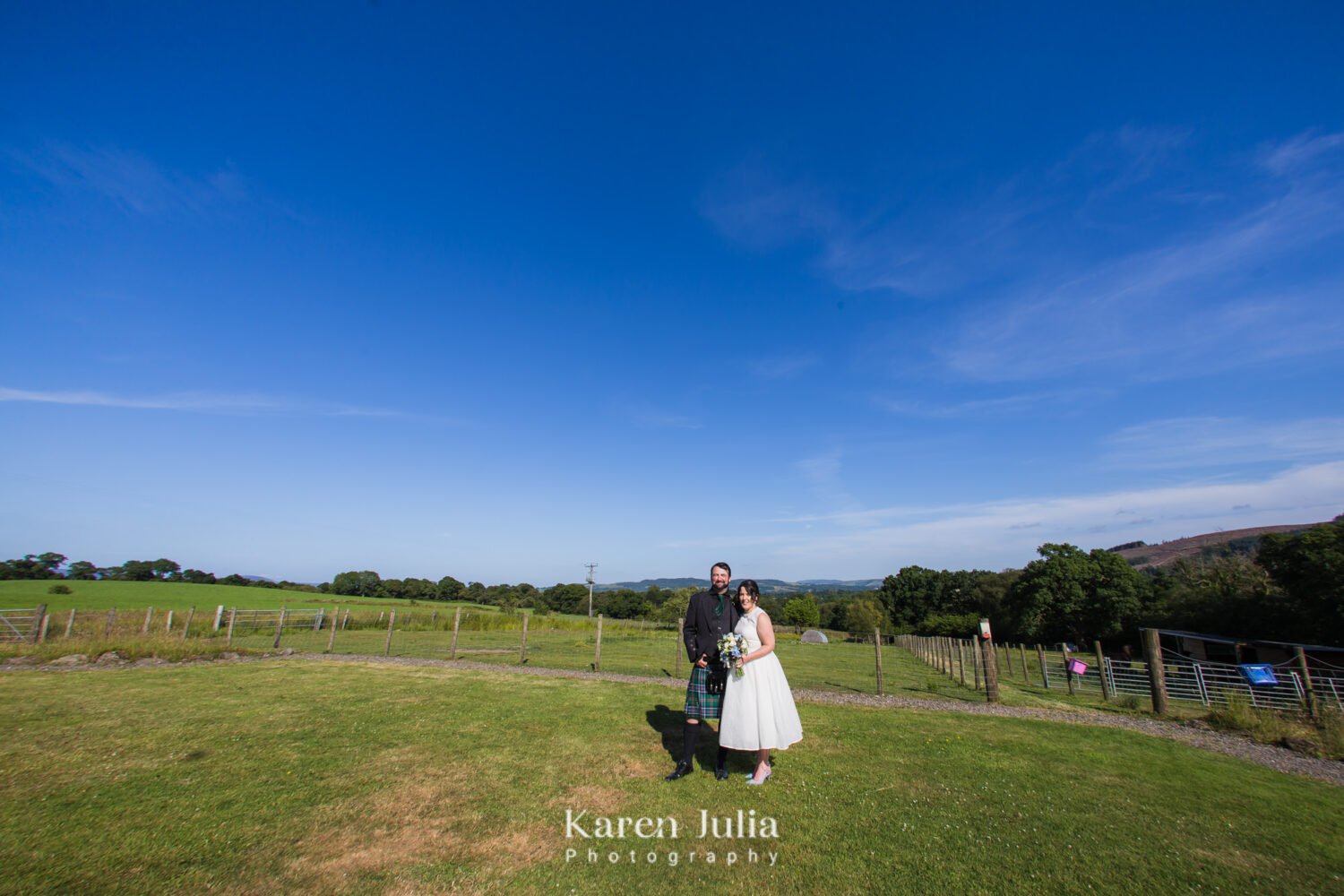 bride and groom portrait at Fruin Farm with Loch Lomond in the background