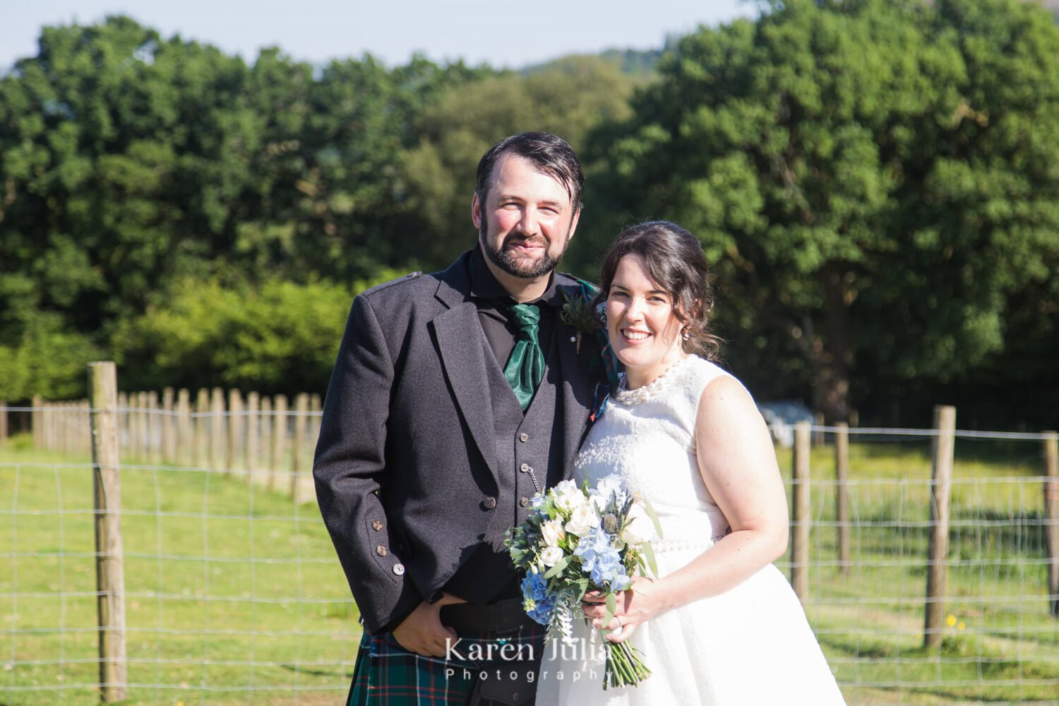 bride and groom portrait near the Llama enclosure at Fruin Farm