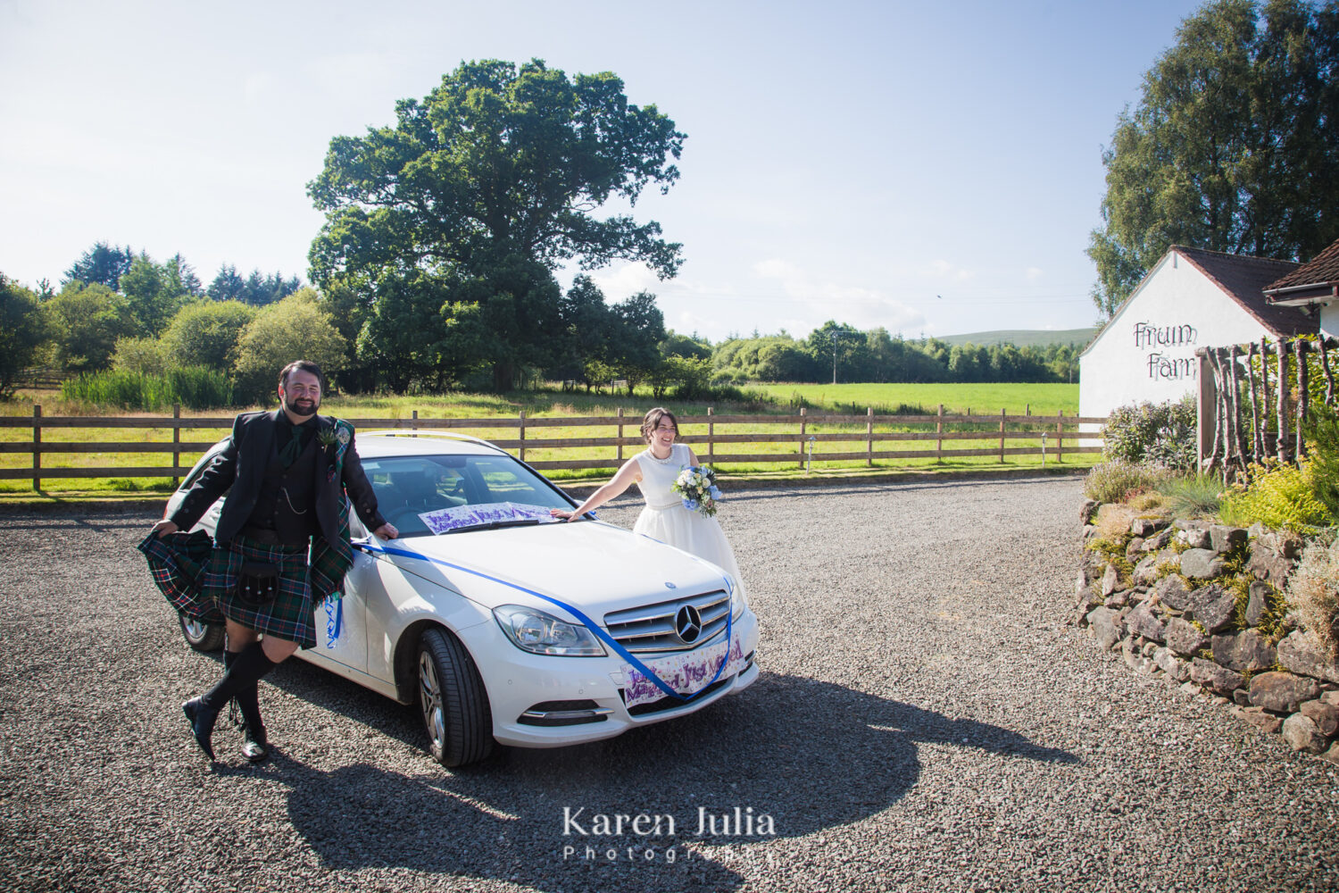 fun wedding car photo with bride and groom