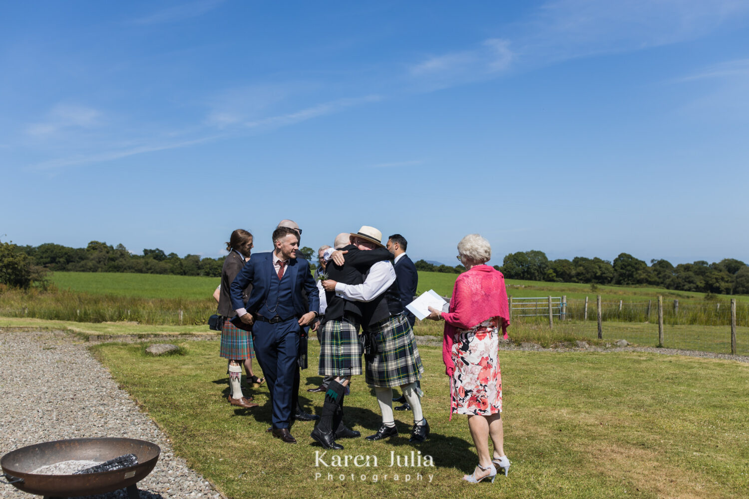 Wedding guests greet each other on the lawn at Fruin Farm