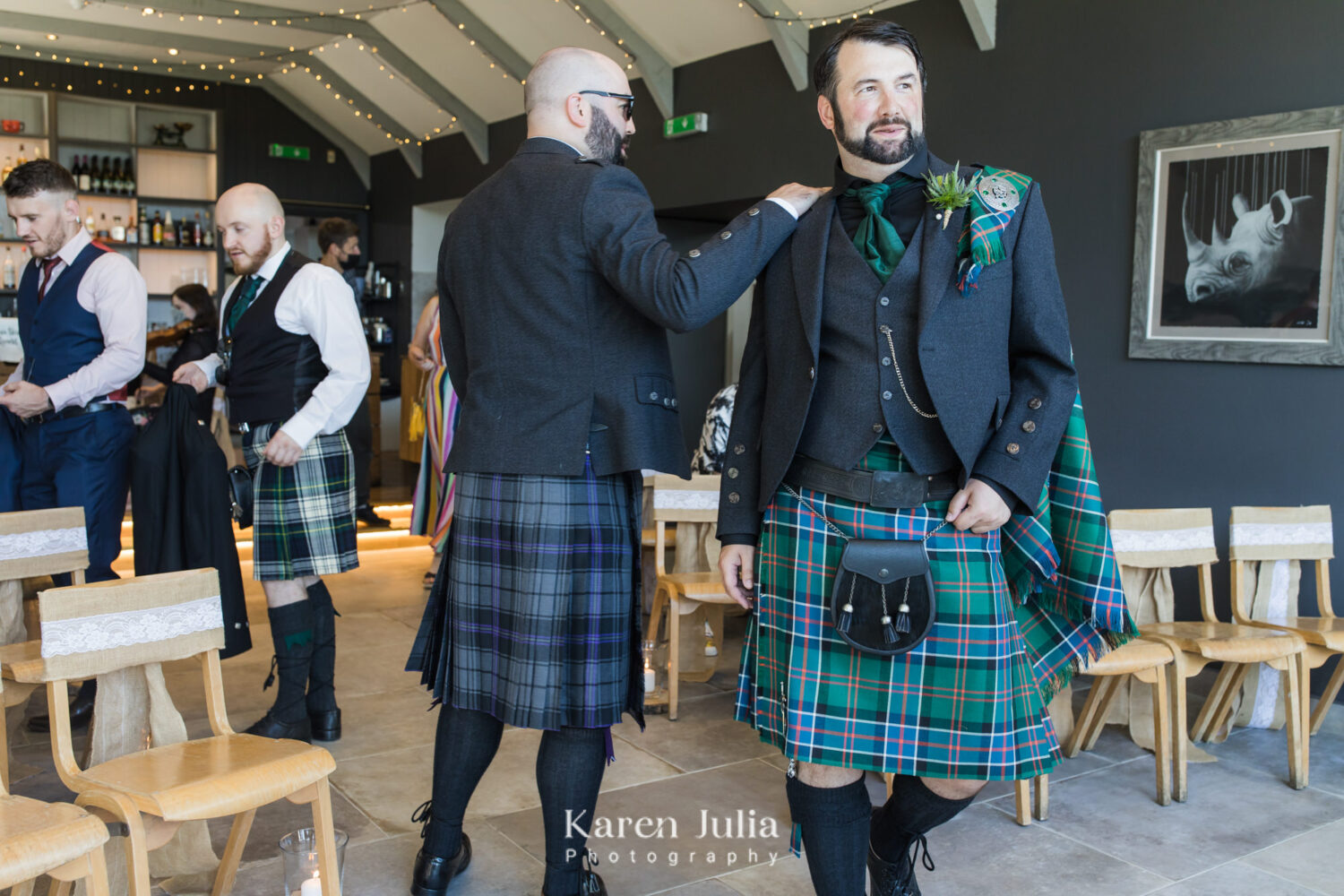 groom walks to the ceremony space in the farmhouse