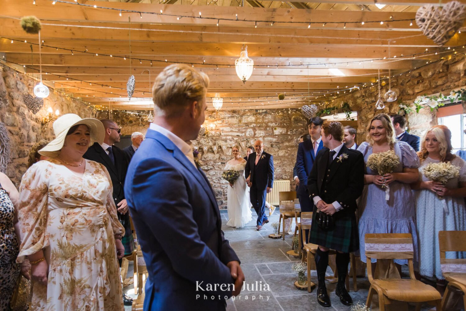 bride walks down the aisle with her Dad in the barn at Fruin Farm