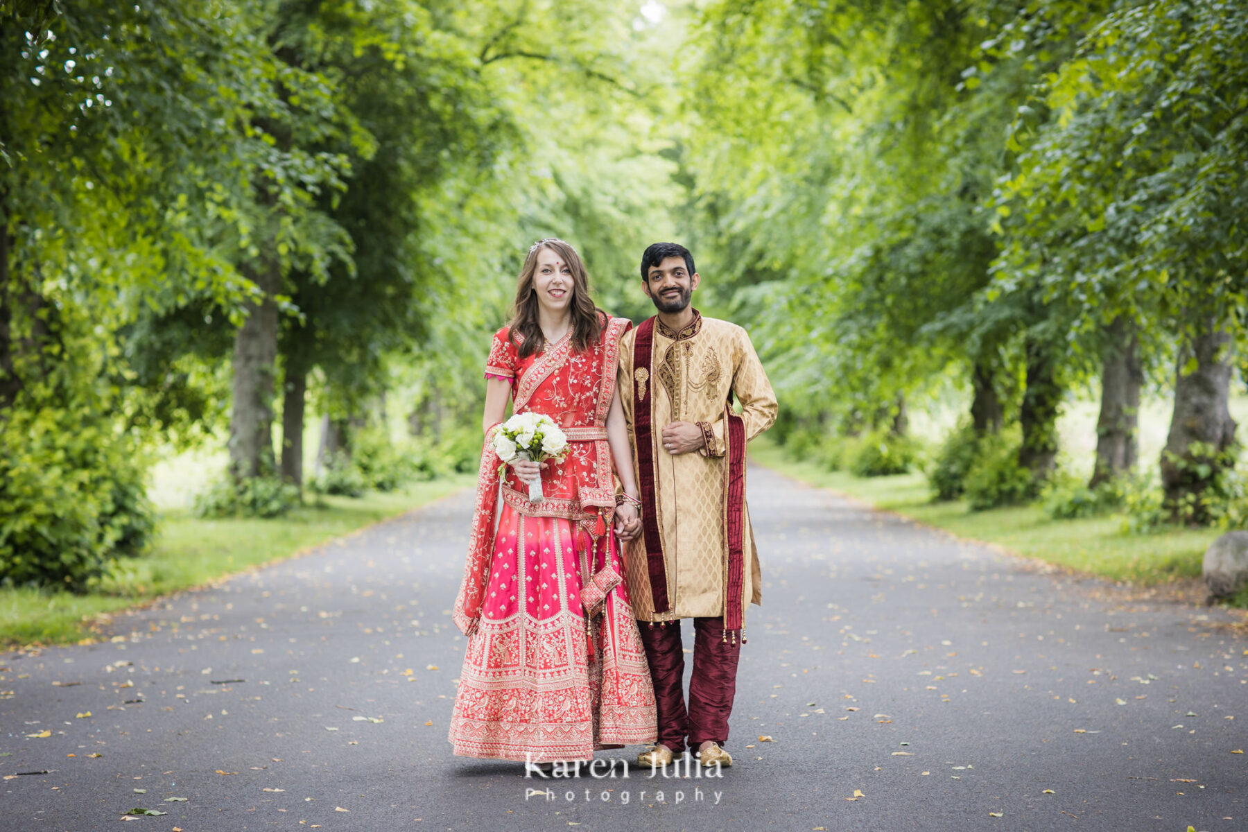 bride and groom pose for a portrait in one of the tree lined walkways at Bellahouston Park