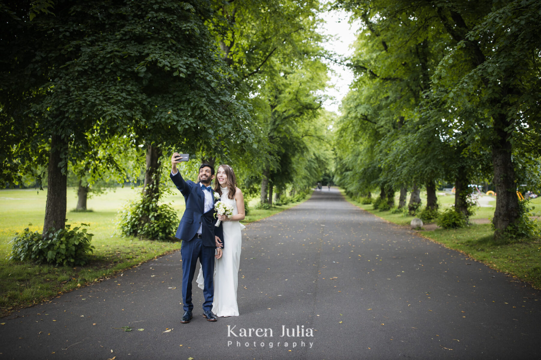 bride and groom take a selfie photo in Bellahouston Park