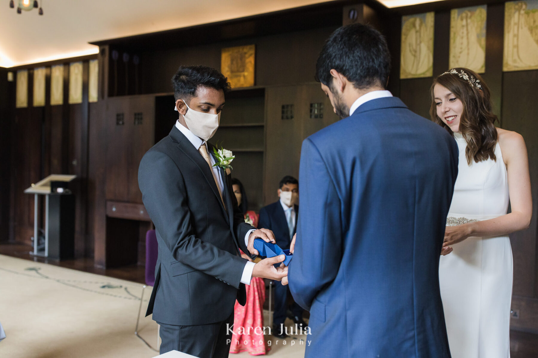best man delivers rings to bride and groom during wedding ceremony at House for an Art Lover