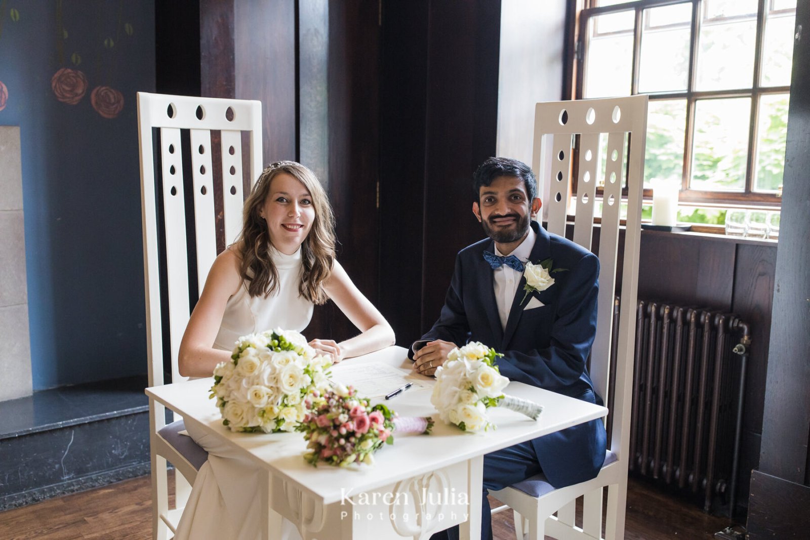 bride and groom pose with the wedding register