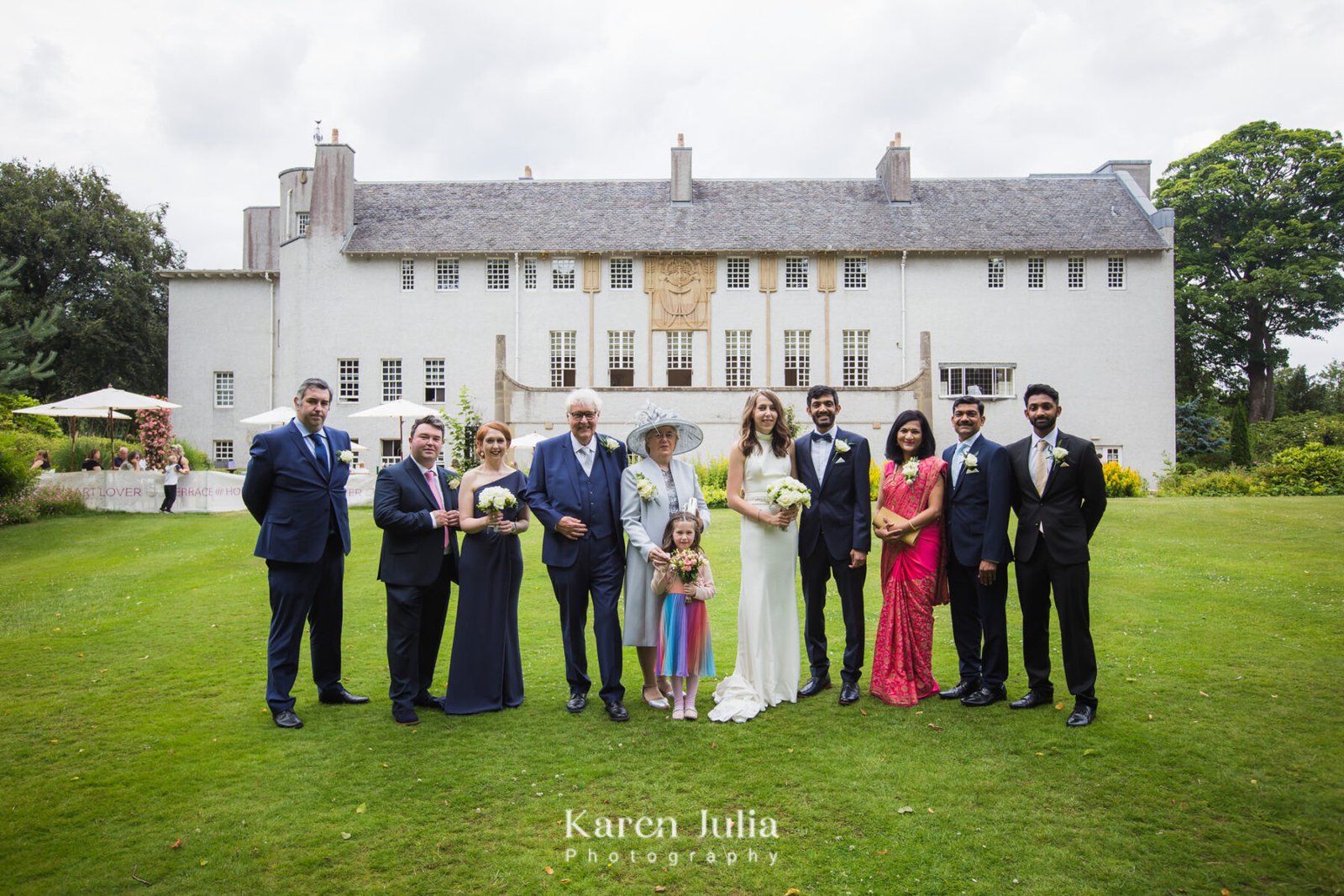 group wedding photo in front of House for an art Lover