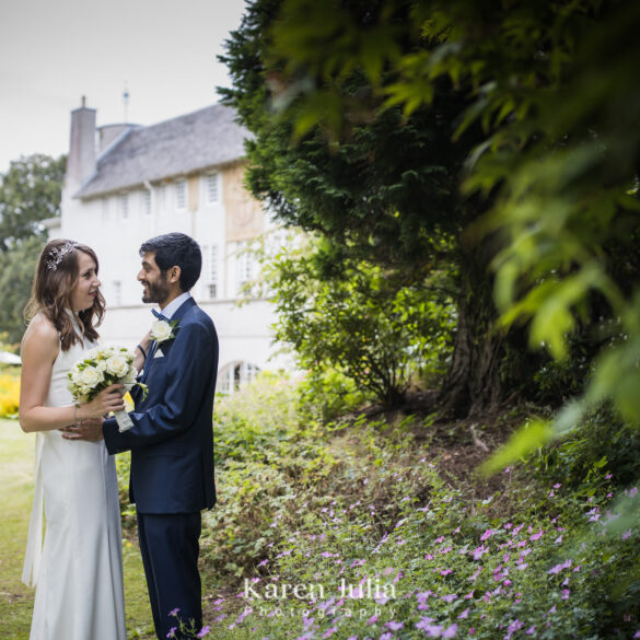 bride and groom standing in the gardens in front of House for an Art Lover