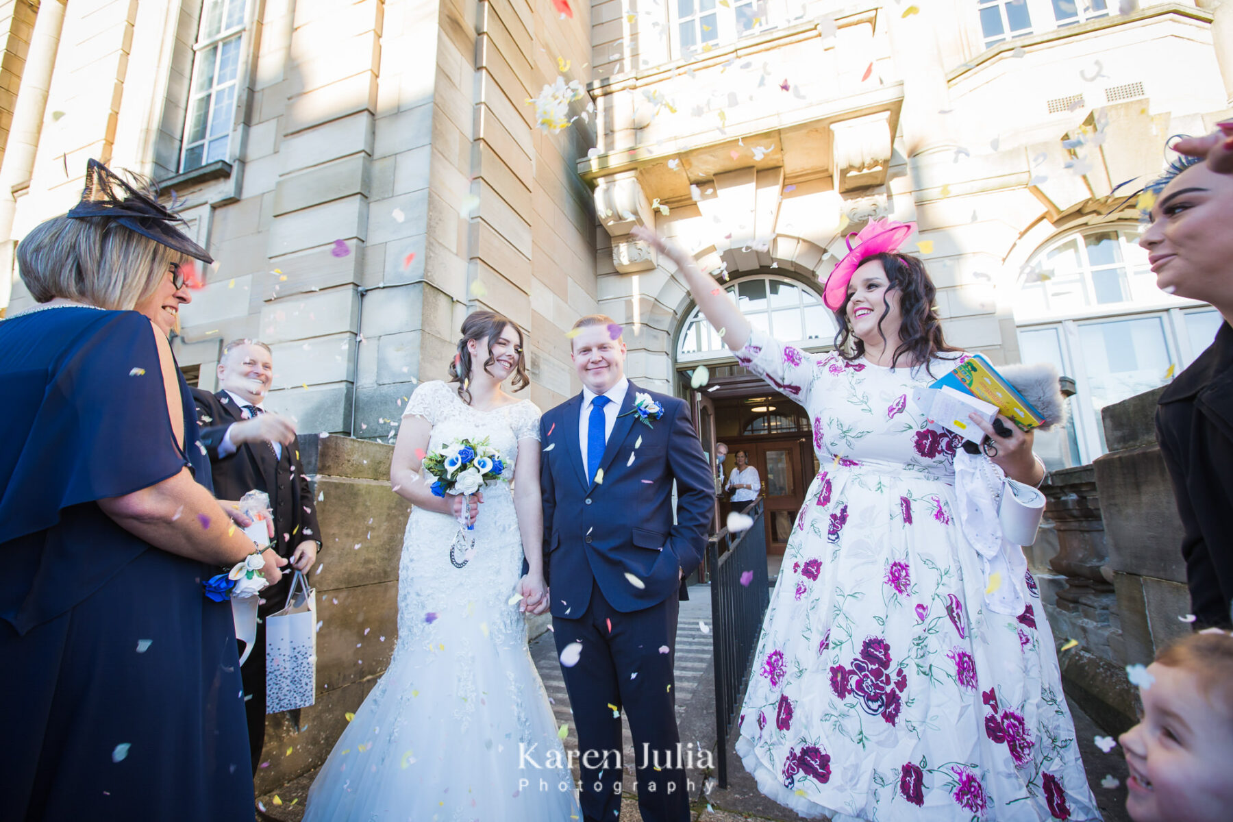 guests shower bride and groom with confetti