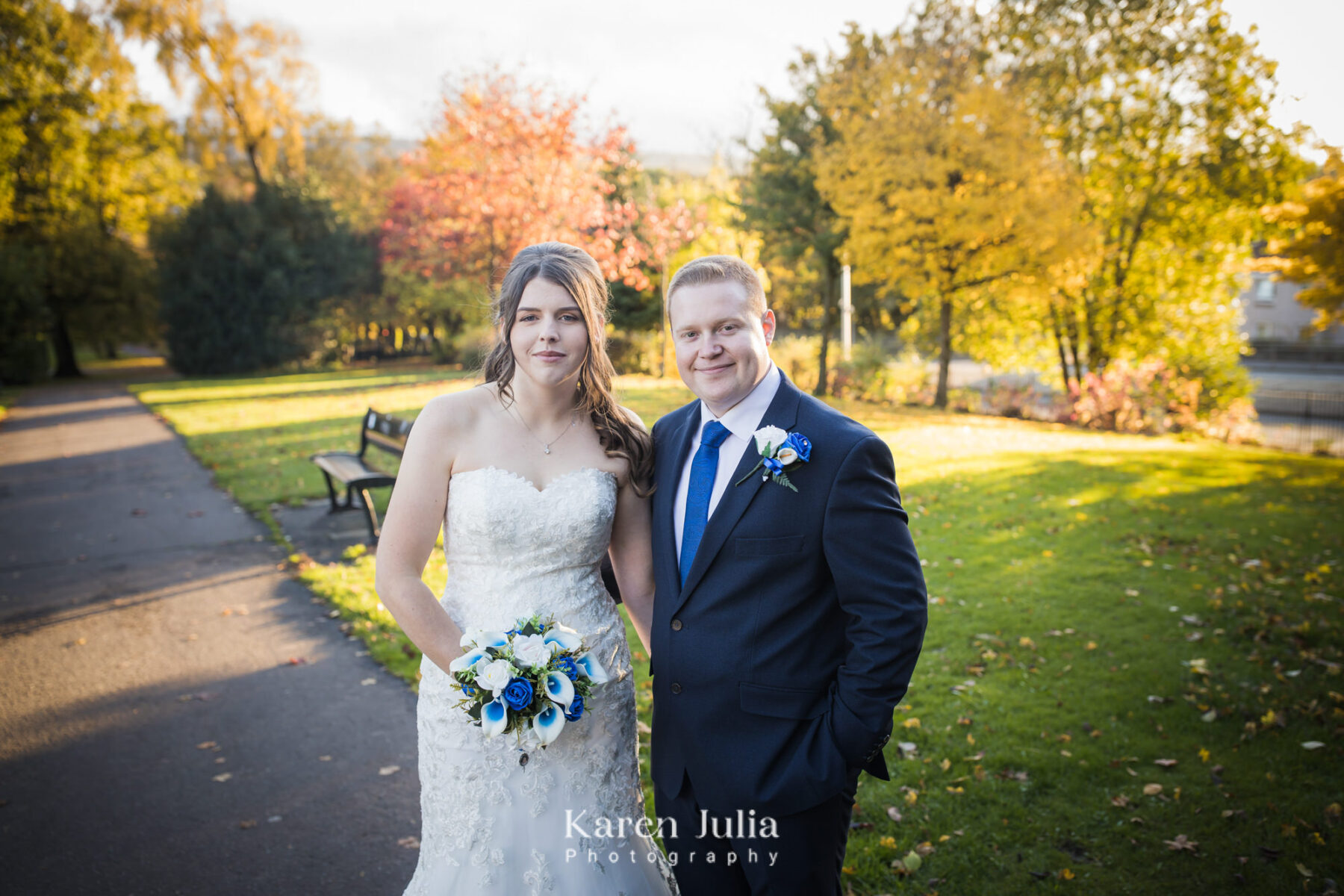 bride and groom pose for a wedding day portrait in Rutherglen's Overtoun Park