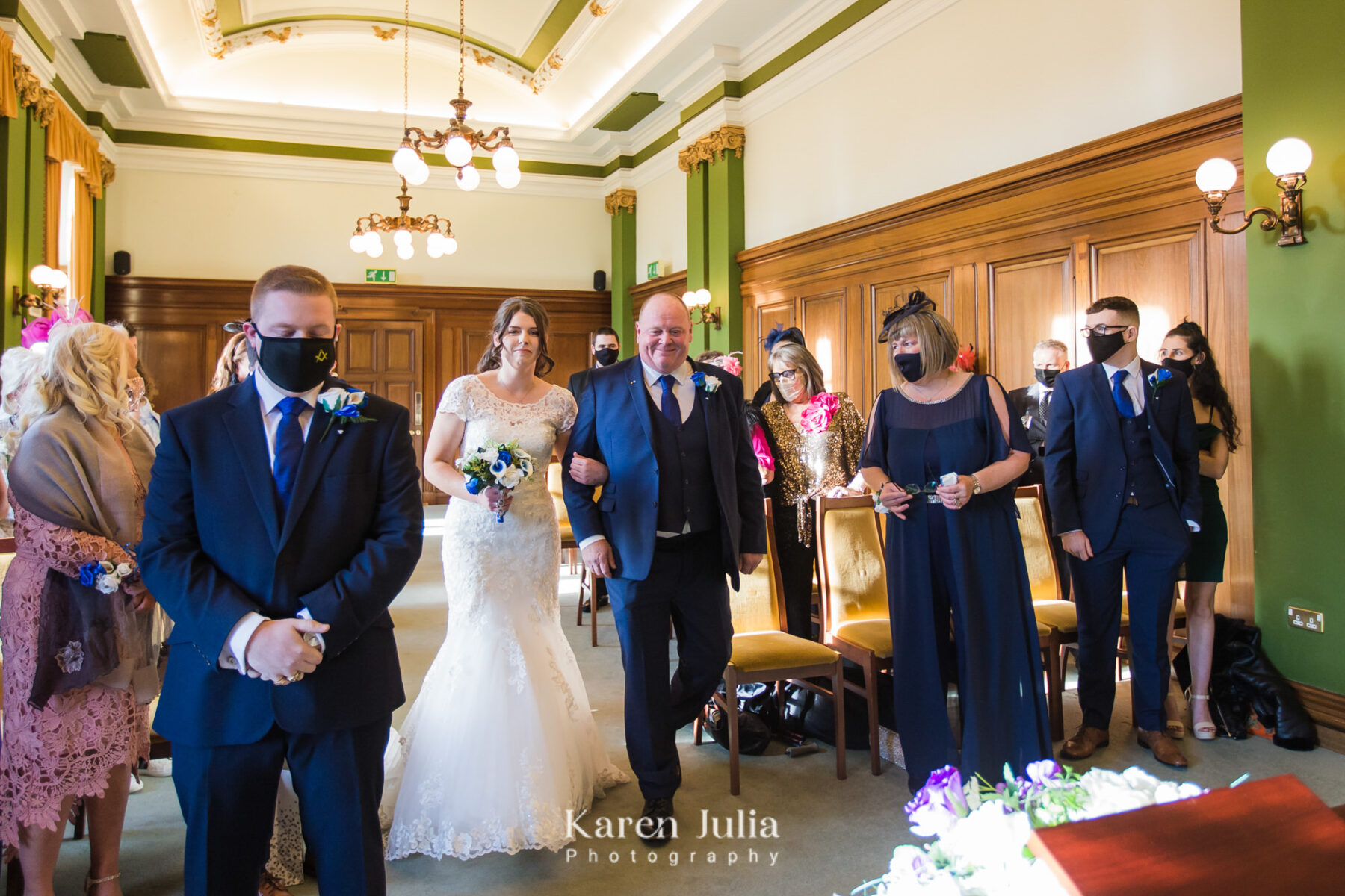bride walks down aisle in The Town House with her dad ready to meet her groom