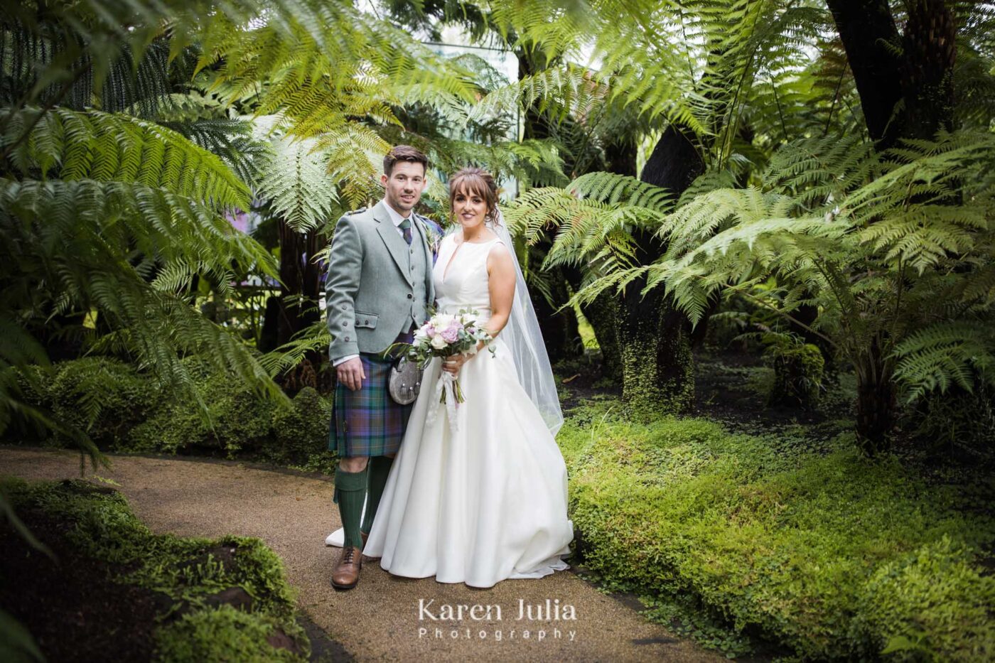 bride and groom pose for a portrait in the botanic gardens
