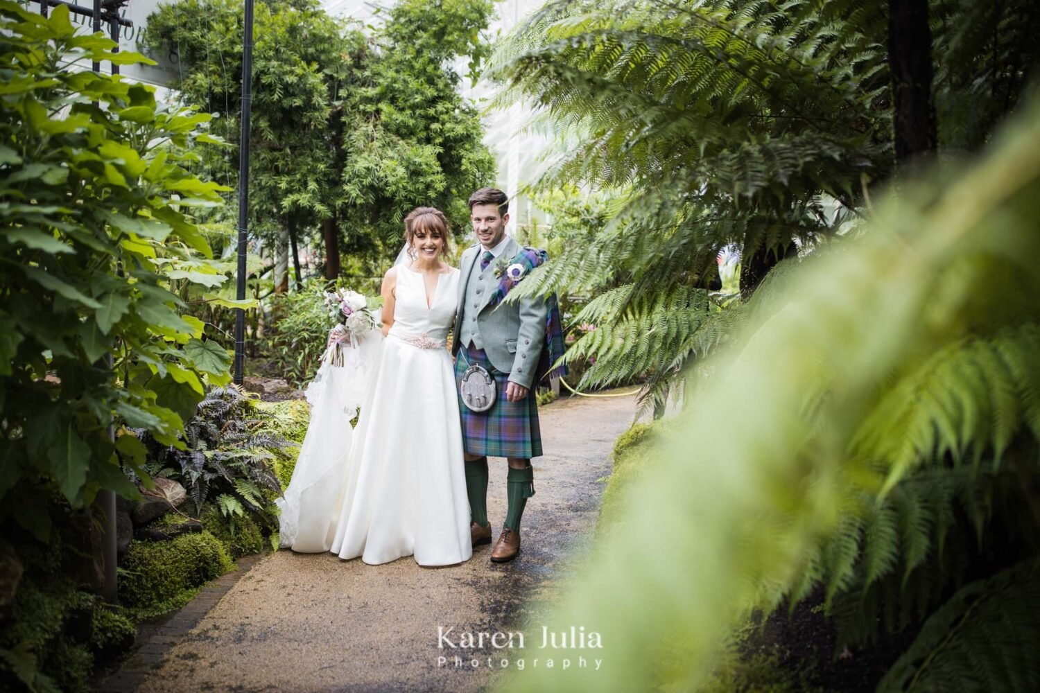 bride and groom pose for a portrait in Glasgow Botanic Gardens