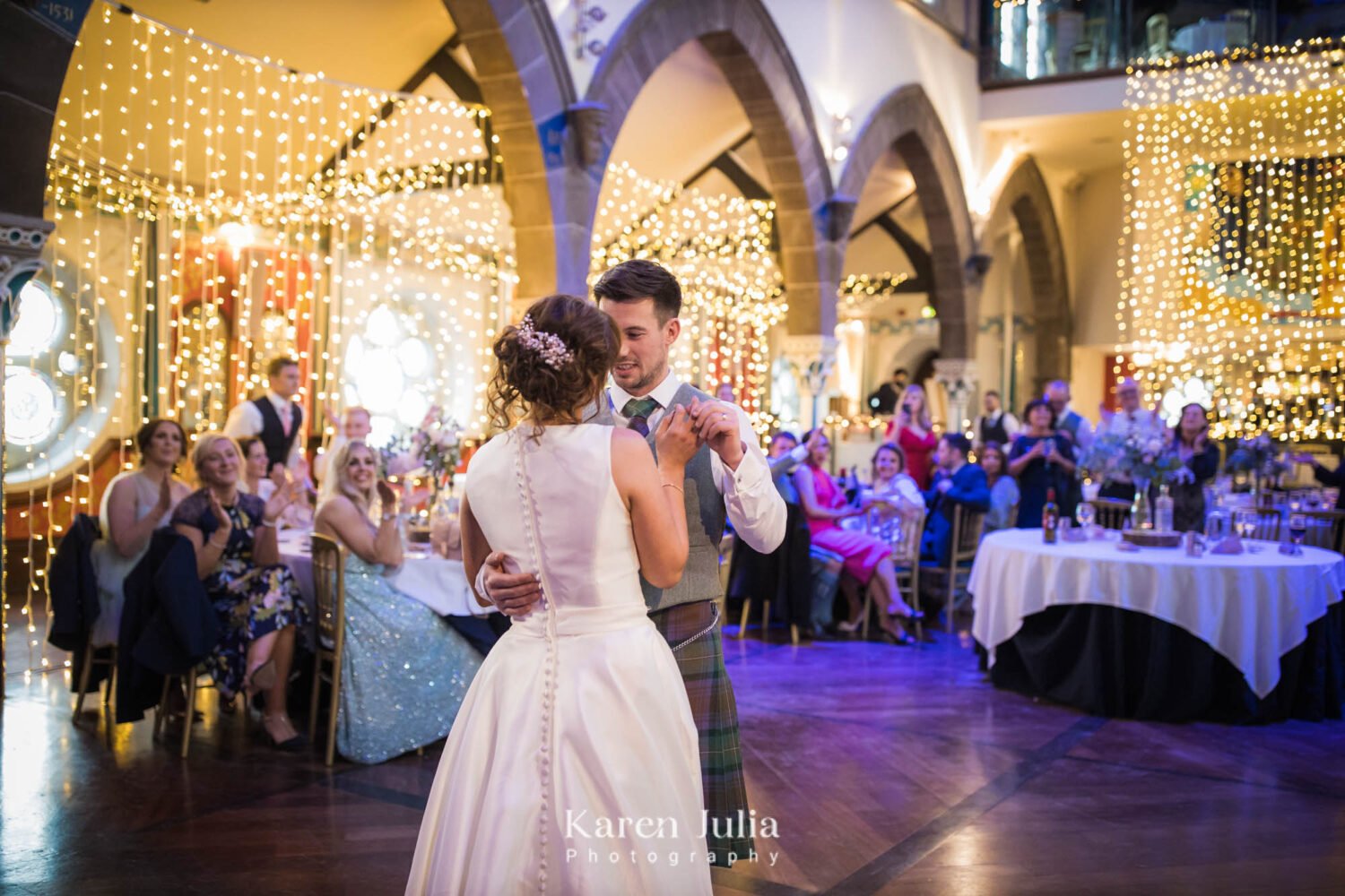 bride and groom have their first dance at their Oran Mor wedding as guests watch