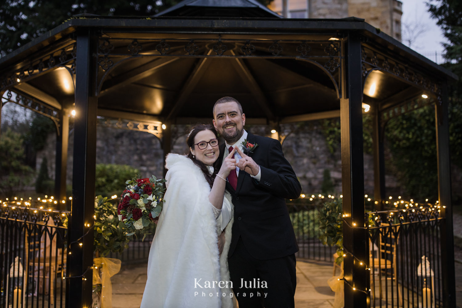 bride and groom portrait surrounded by fairy lights