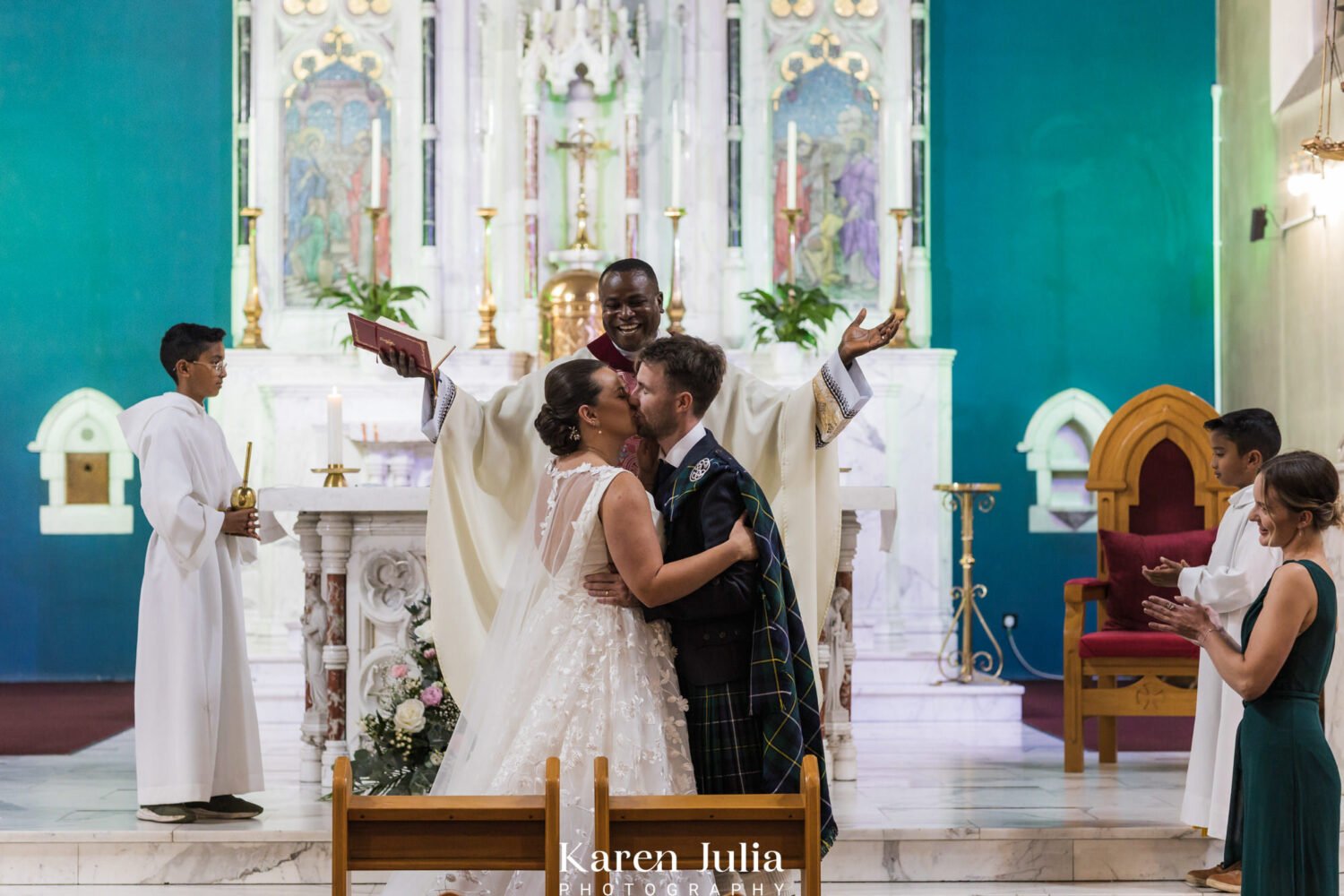 bride and groom celebrate getting married with a kiss at the end of their wedding ceremony