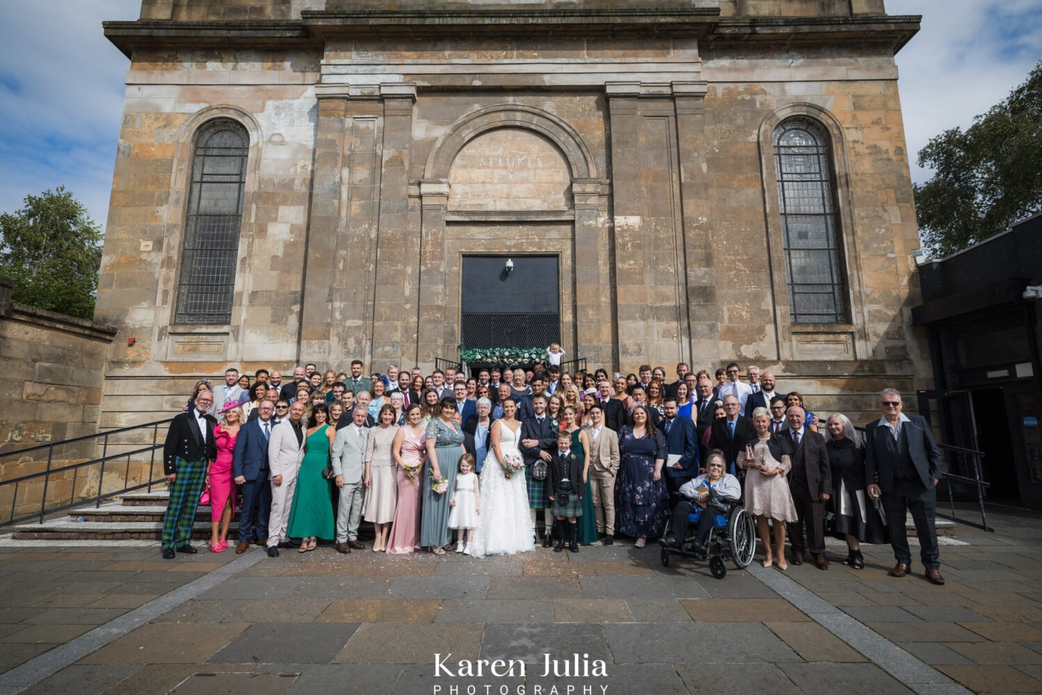 group photos of all wedding guests outside Saint Luke's and the winged ox