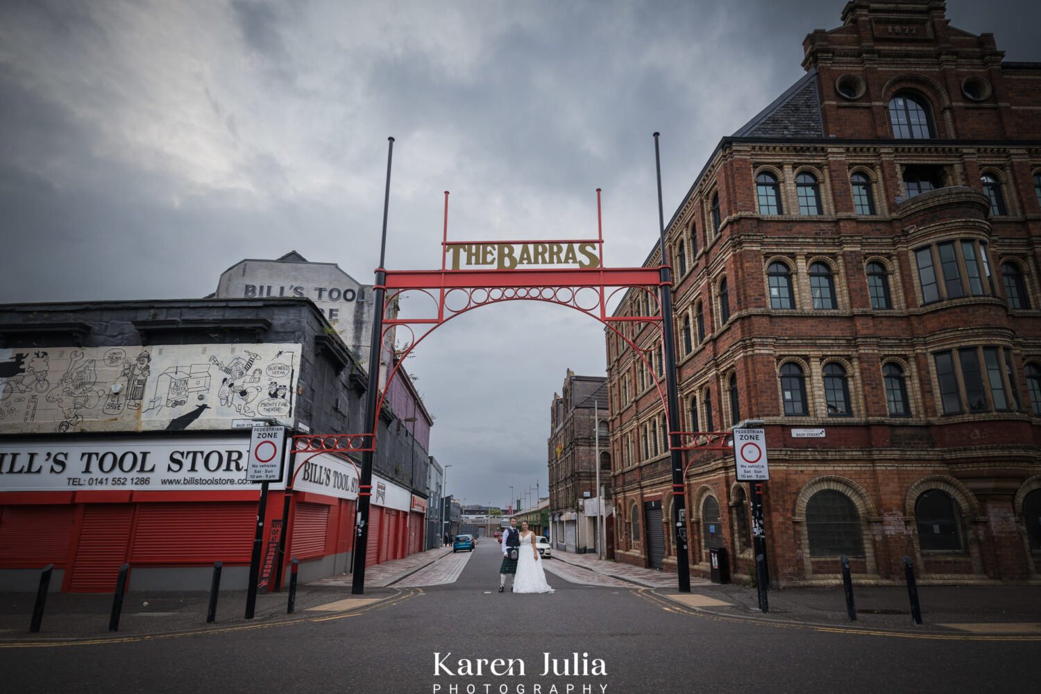 bride and groom wedding day portrait under the Barra's sign.