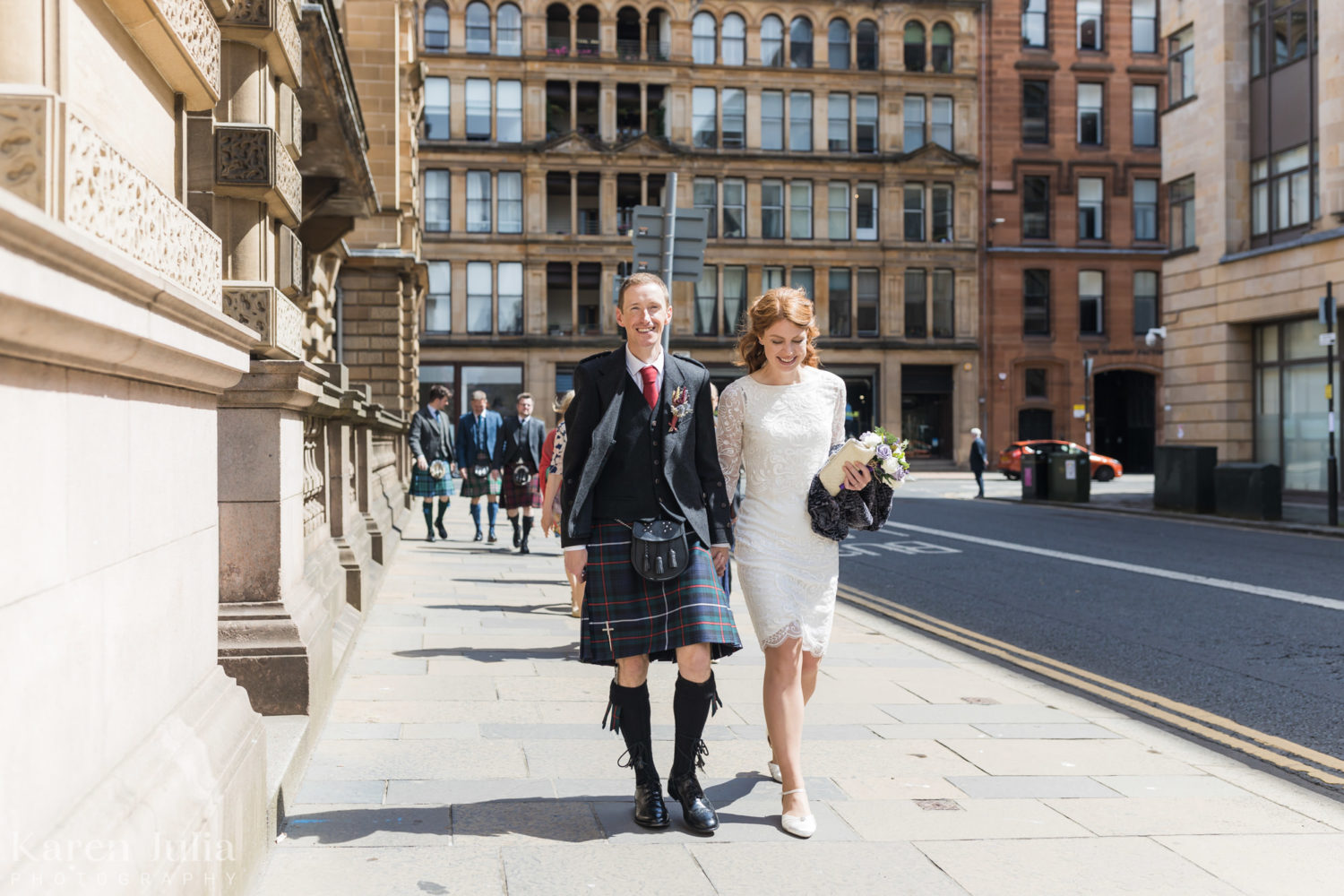 bride and groom walking together at the side of the City Chambers