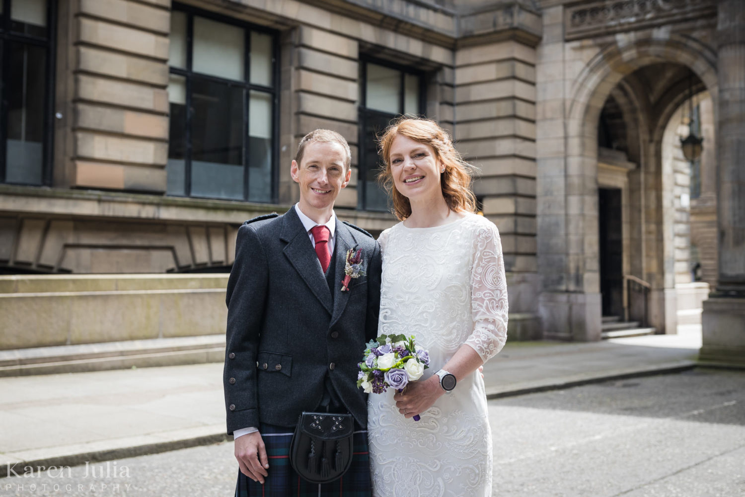 bride and groom standing together in John Street during wedding portraits