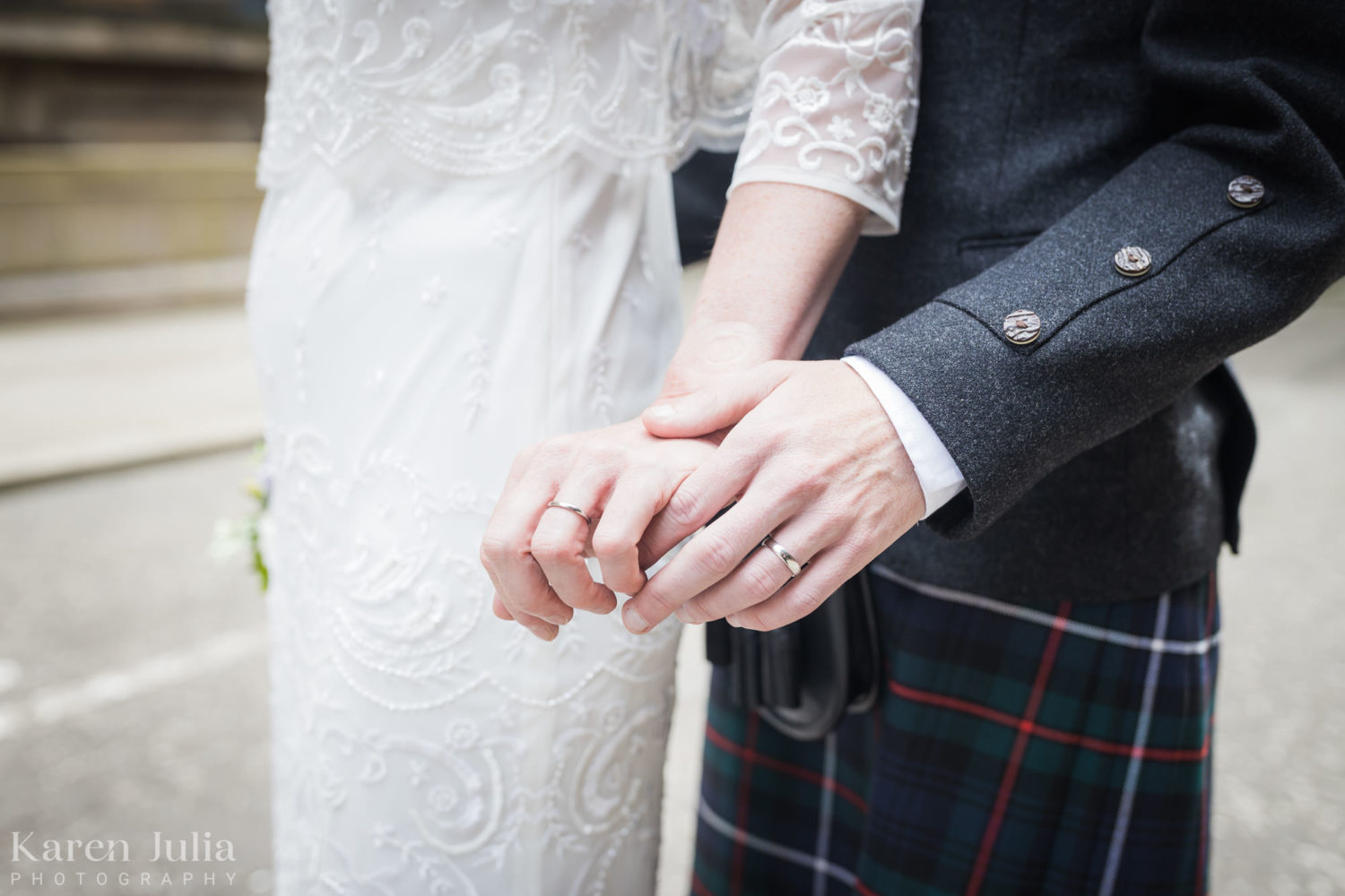 detail photo of bride and groom wedding rings