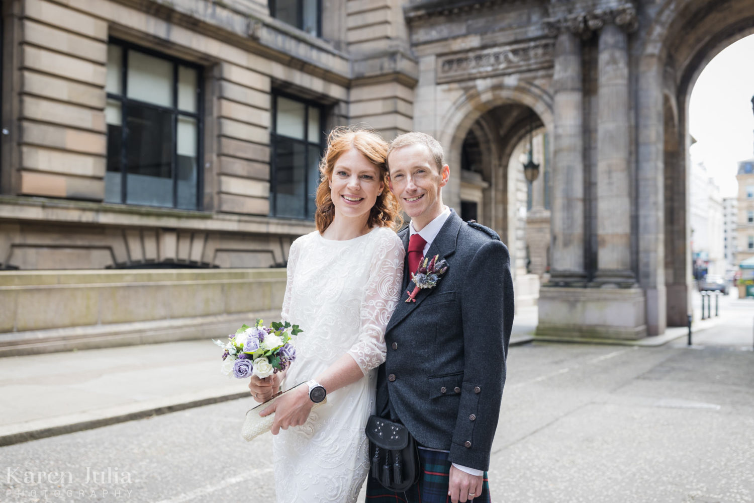 groom snuggles up to bride during wedding photos in John Street
