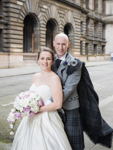 bride and groom pose for a wedding day portrait in John Street