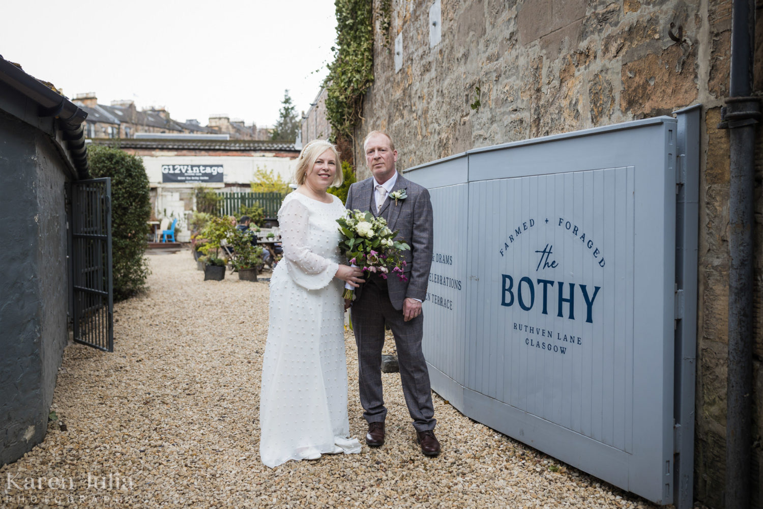 bride and groom next to the entrance of the Bothy on their wedding day