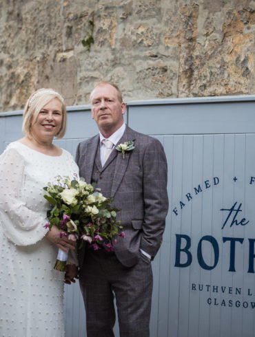 bride and groom pose for a portrait at the entrance of the Bothy on Ruthven Lane