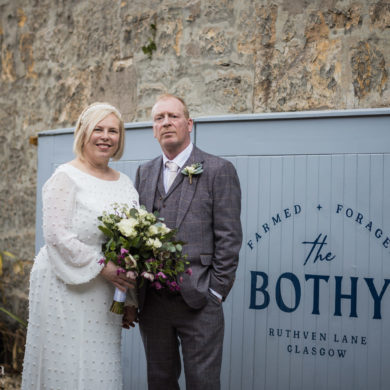 bride and groom pose for a portrait at the entrance of the Bothy on Ruthven Lane