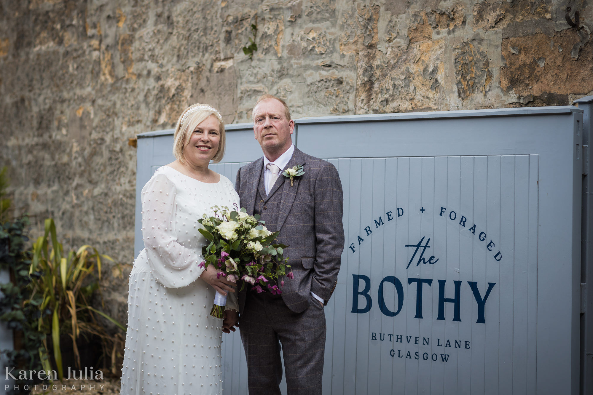 bride and groom pose for a portrait at the entrance of the Bothy on Ruthven Lane