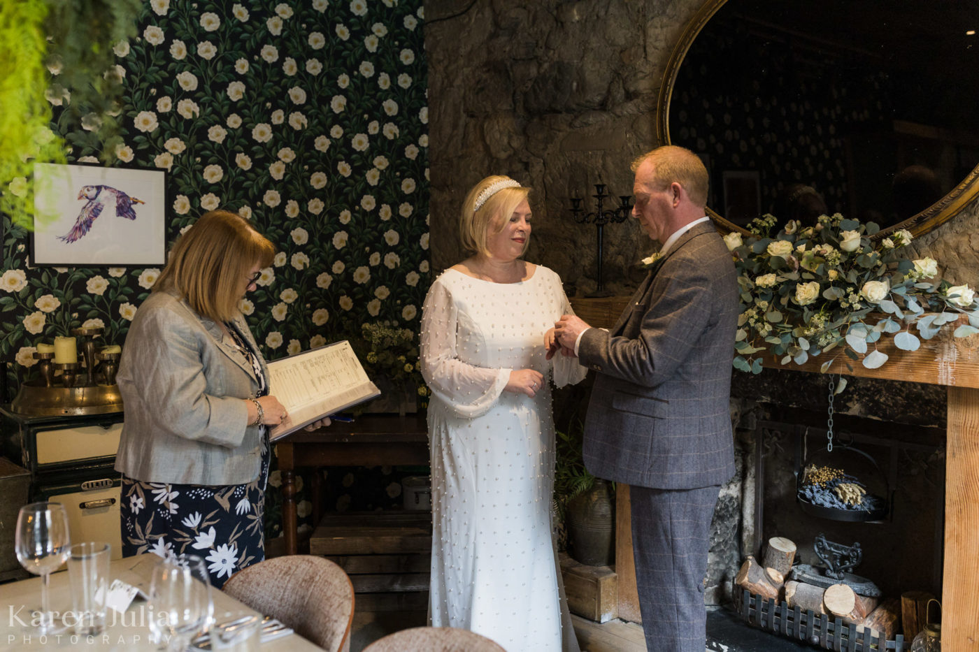bride and groom exchanging ring during their wedding ceremony at the Bothy