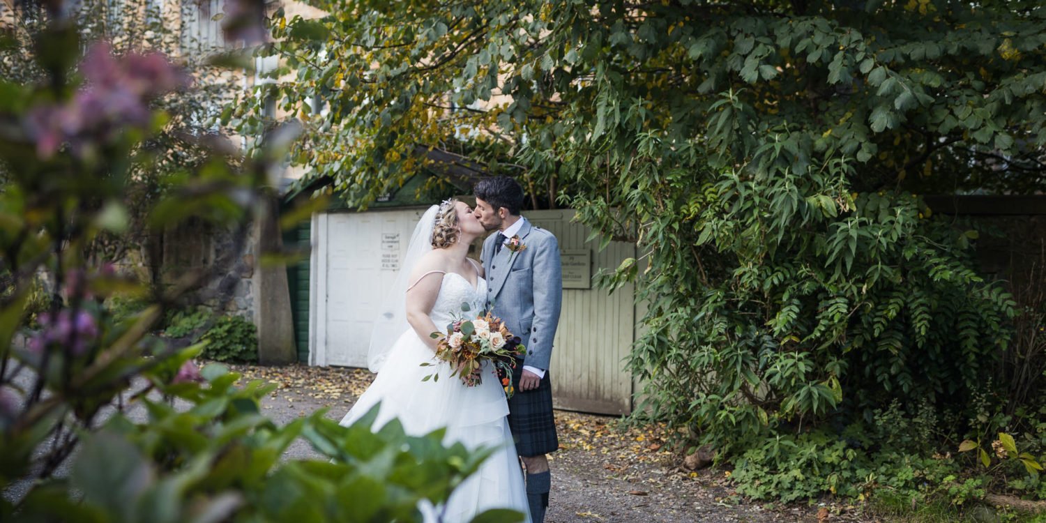 bride and groom kiss during their portrait session in Victoria Crescent Lane