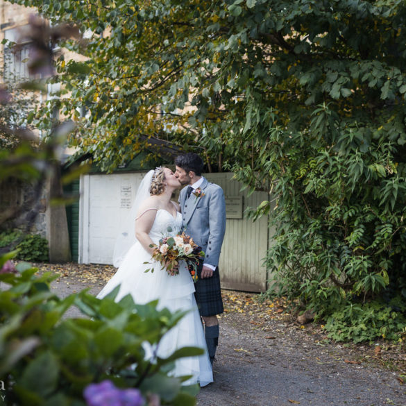 bride and groom kiss during their portrait session in Victoria Crescent Lane
