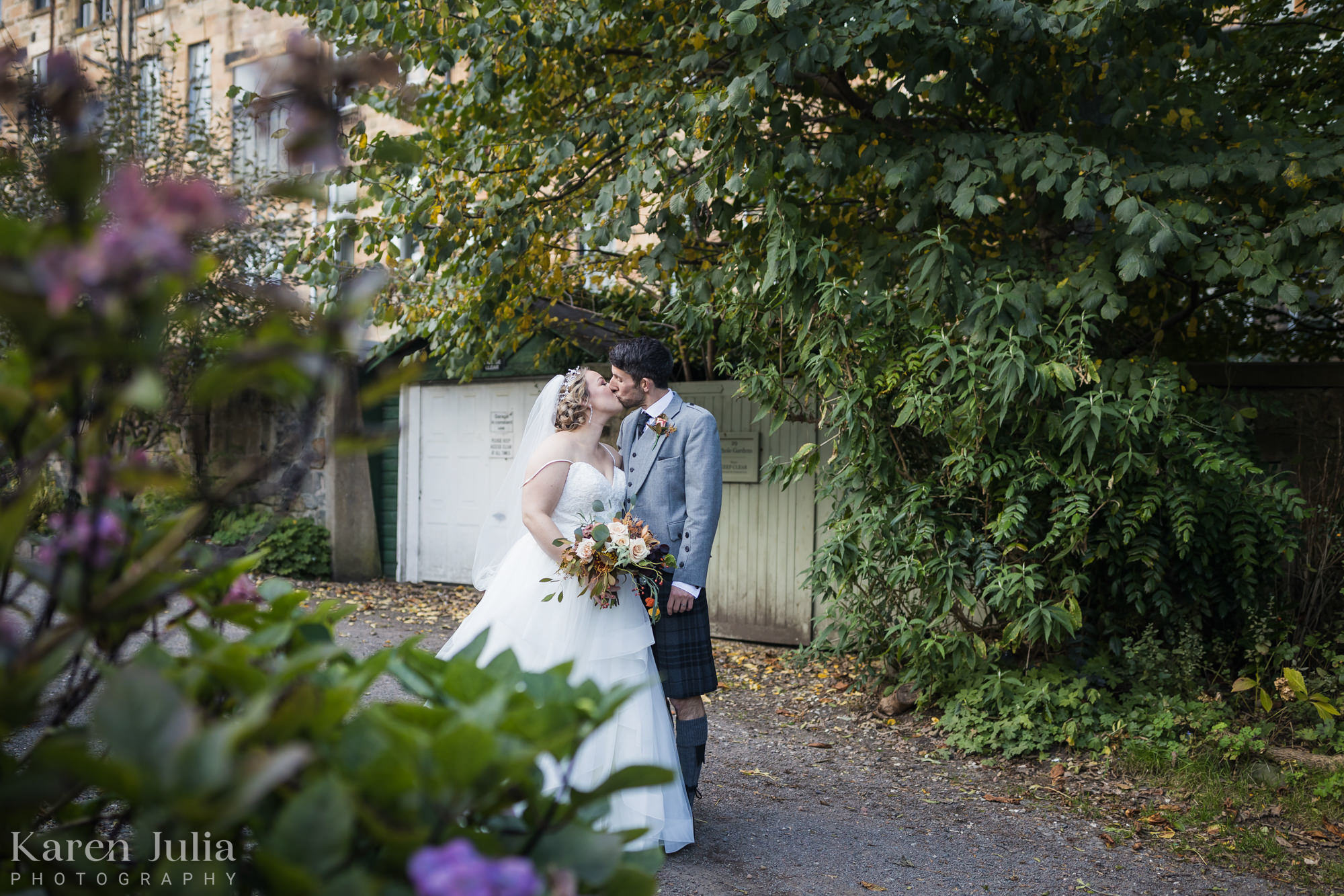 bride and groom kiss during their portrait session in Victoria Crescent Lane