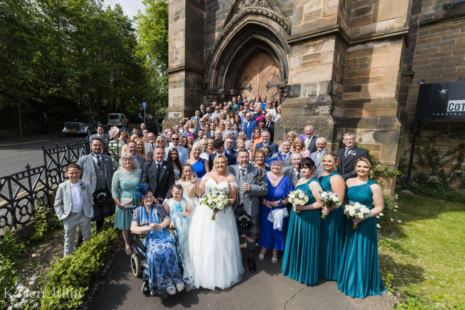 wedding party group photo of all wedding guests outside Cottiers