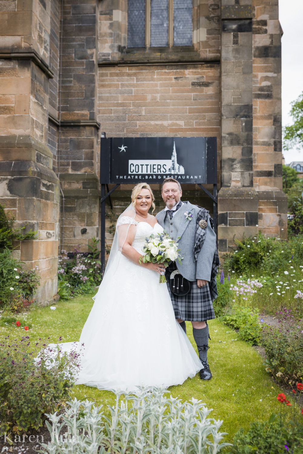 bride and groom portrait at the front of Cottiers