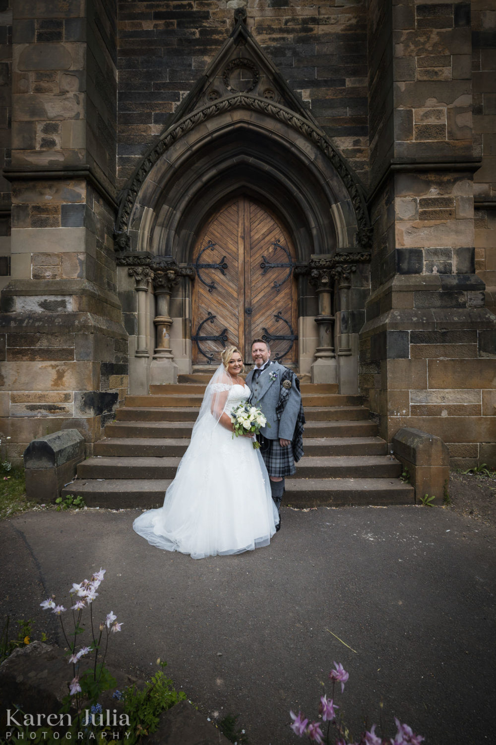 bride and groom portrait outside the church doors at Cottiers