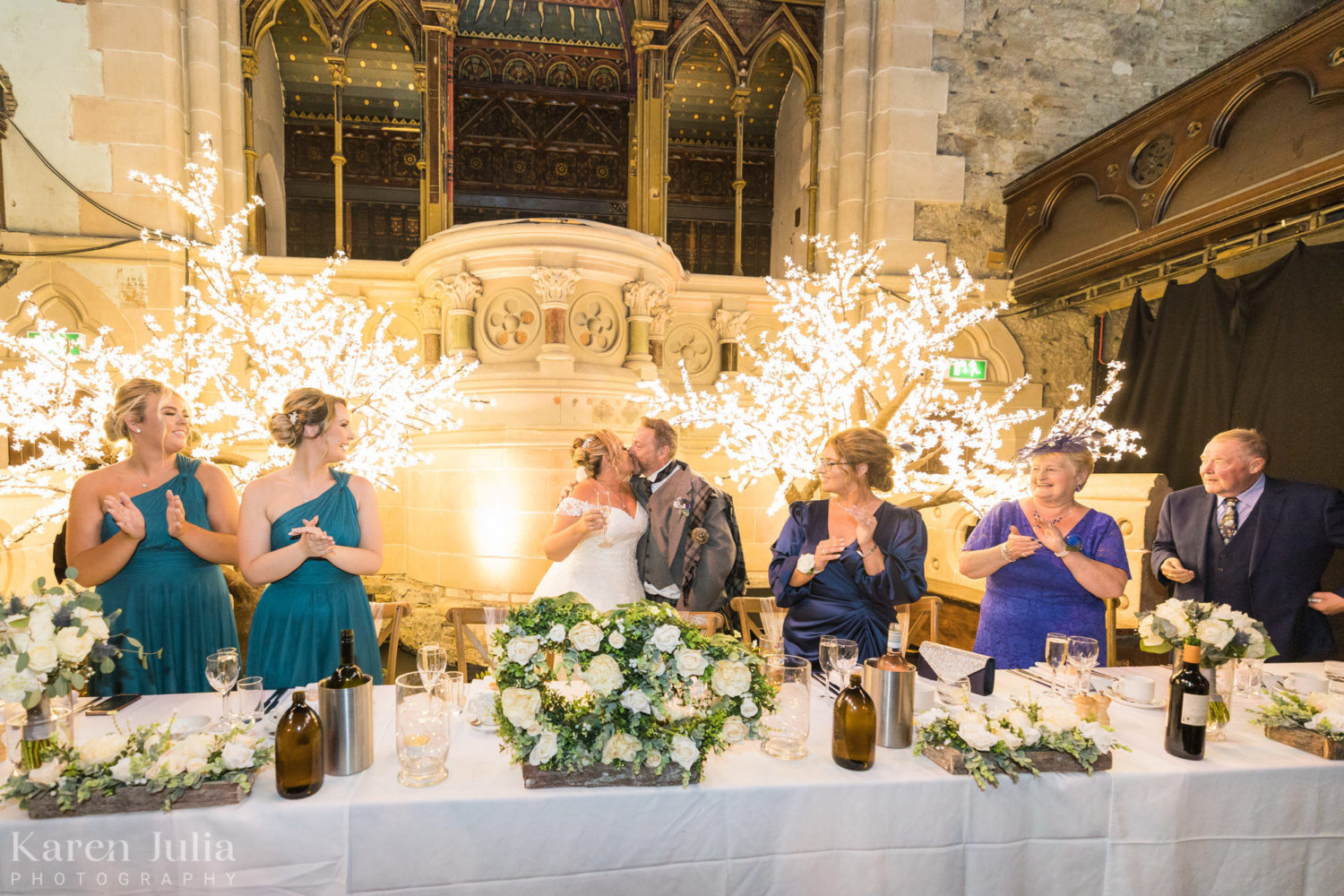 bride and groom share a kiss at the top table