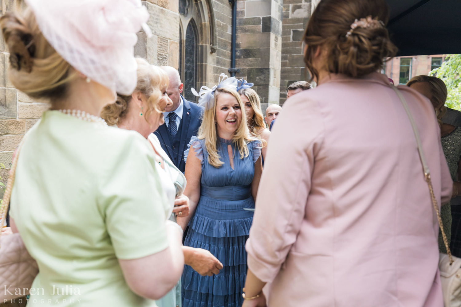 wedding guests chatting outside Cottiers in the courtyard before the wedding ceremony