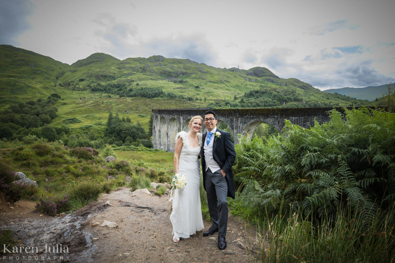 bride and groom in front of Glenfinnan Viaduct