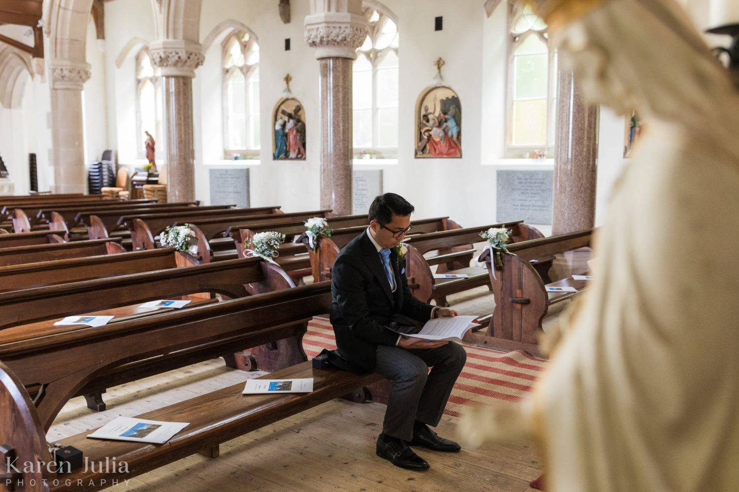 groom reading in the church before the bride arrives