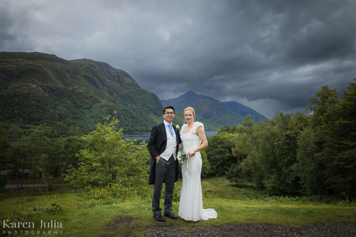 bride and groom wedding day portrait in front of Loch Shiel