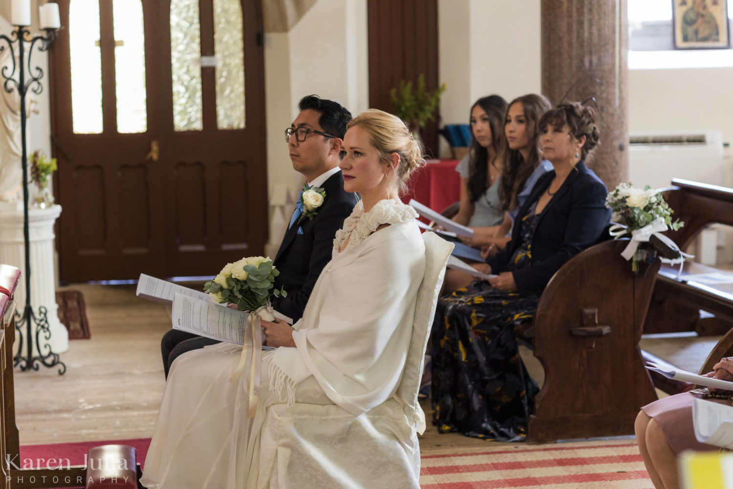 bride and groom sit together during the church wedding ceremony