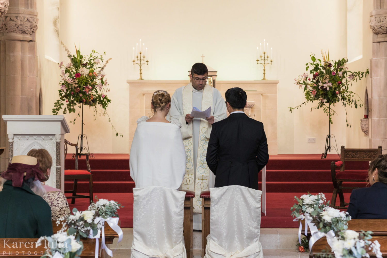 bride and groom listening to a bible reading during the wedding ceremony