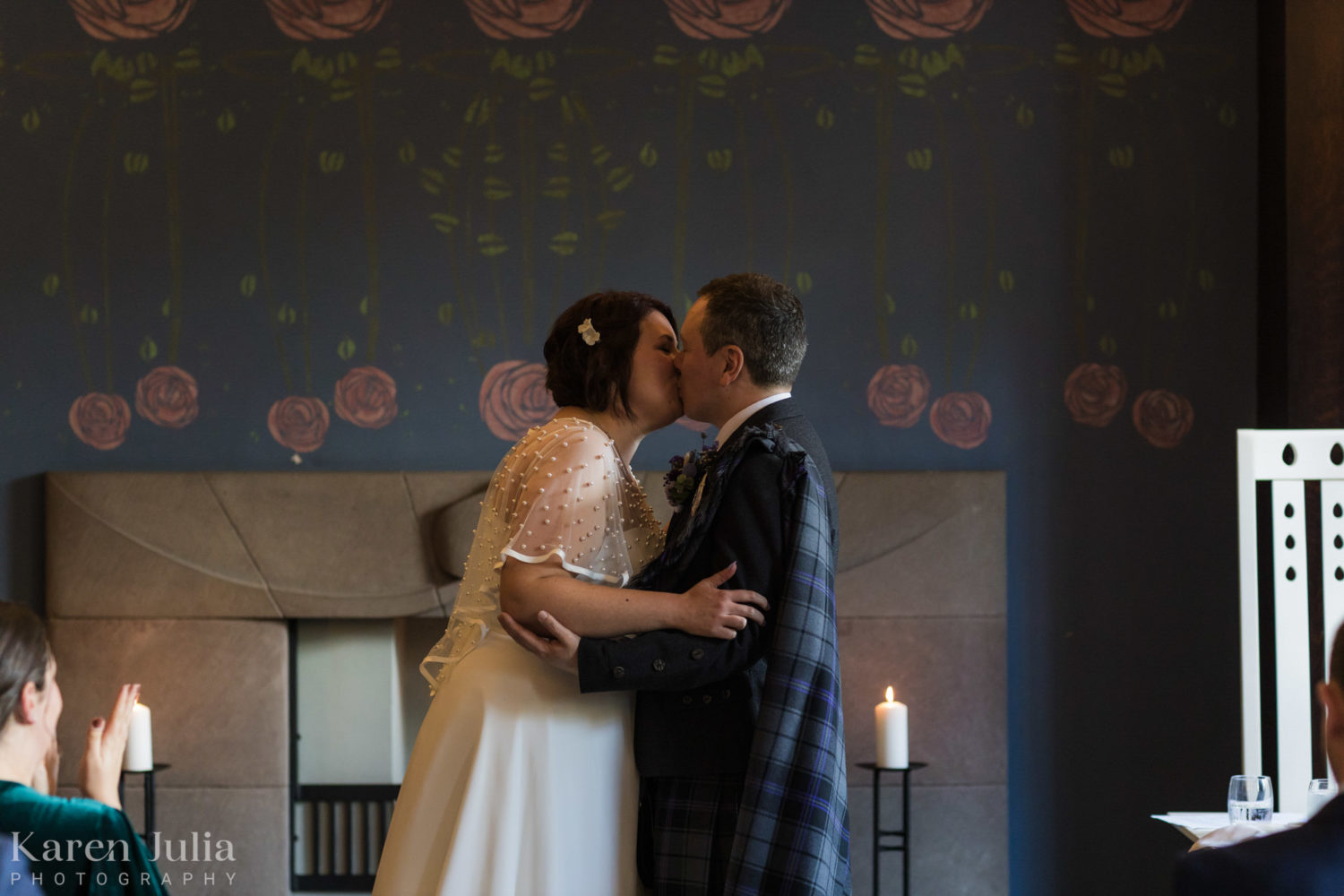 bride and groom kiss at the end of their wedding ceremony in the dining room at House for an art lover