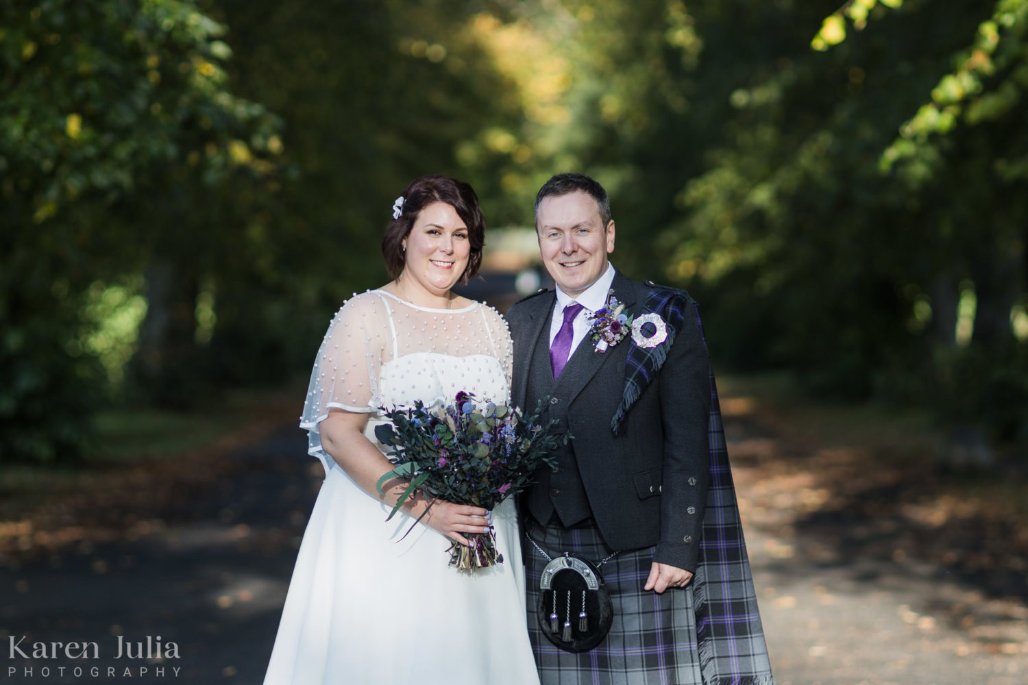 bride and groom wedding day portrait surrounded by trees in Bellahouston  Park