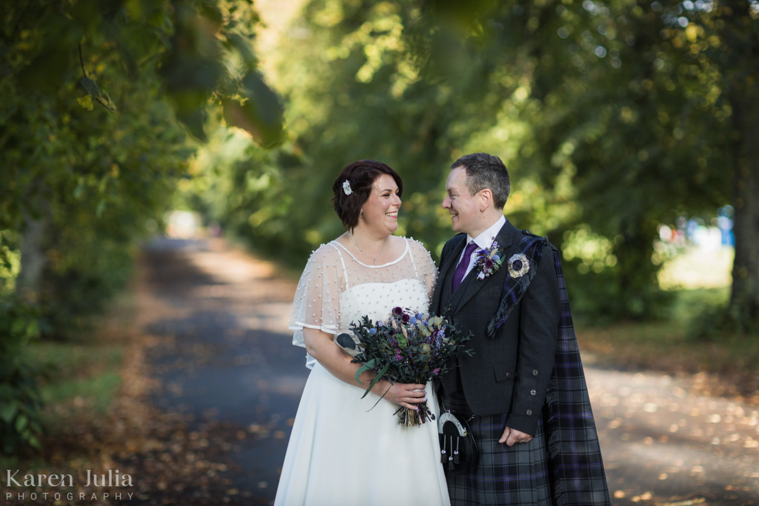bride and groom portrait at the tree lined walkway in Bellahouston Park